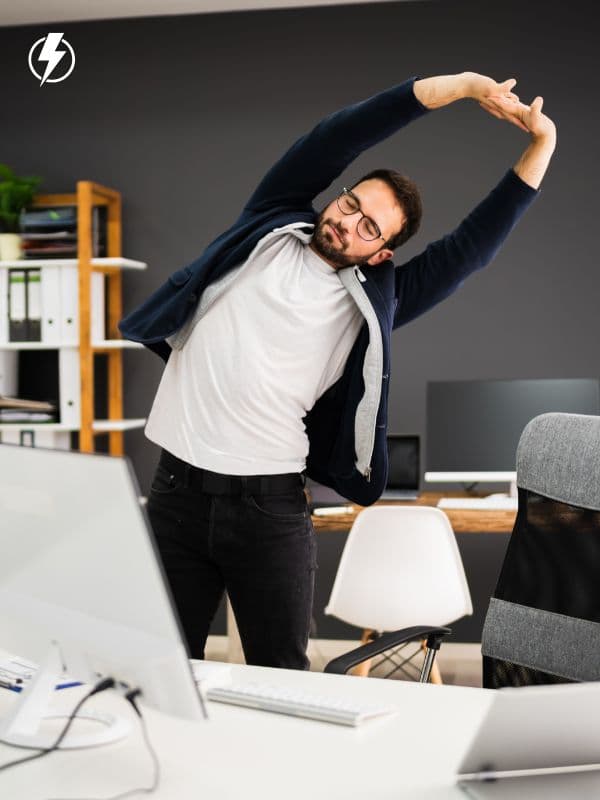Person doing exercise snacks by stretching at their desk